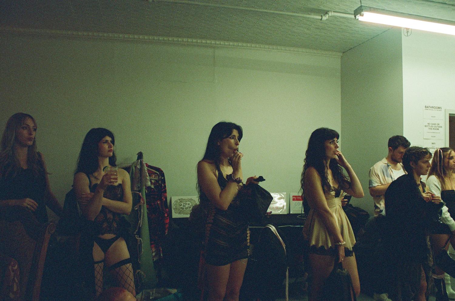 Dancers lined up backstage watching the show